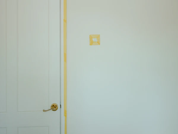 Door trim taped off before painting