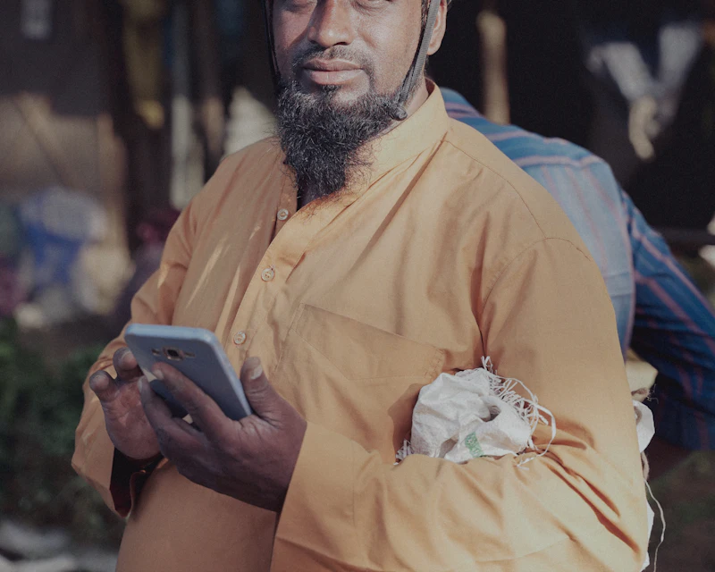 Plumber checking the job on his phone during a service call